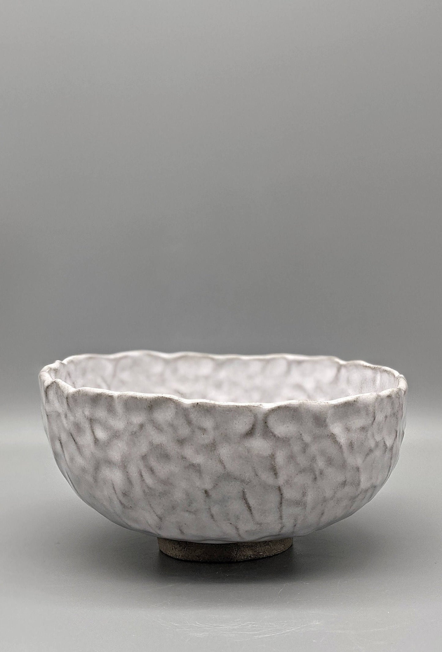 White glaze over concrete clay bowl
